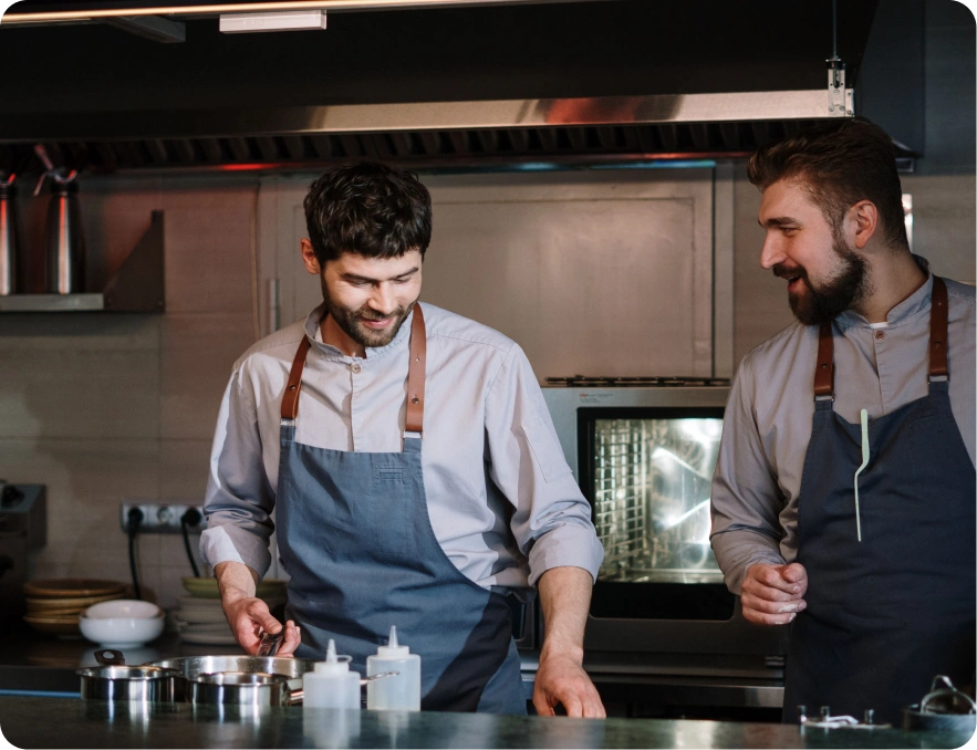 Professional chefs smiling and training in kitchen